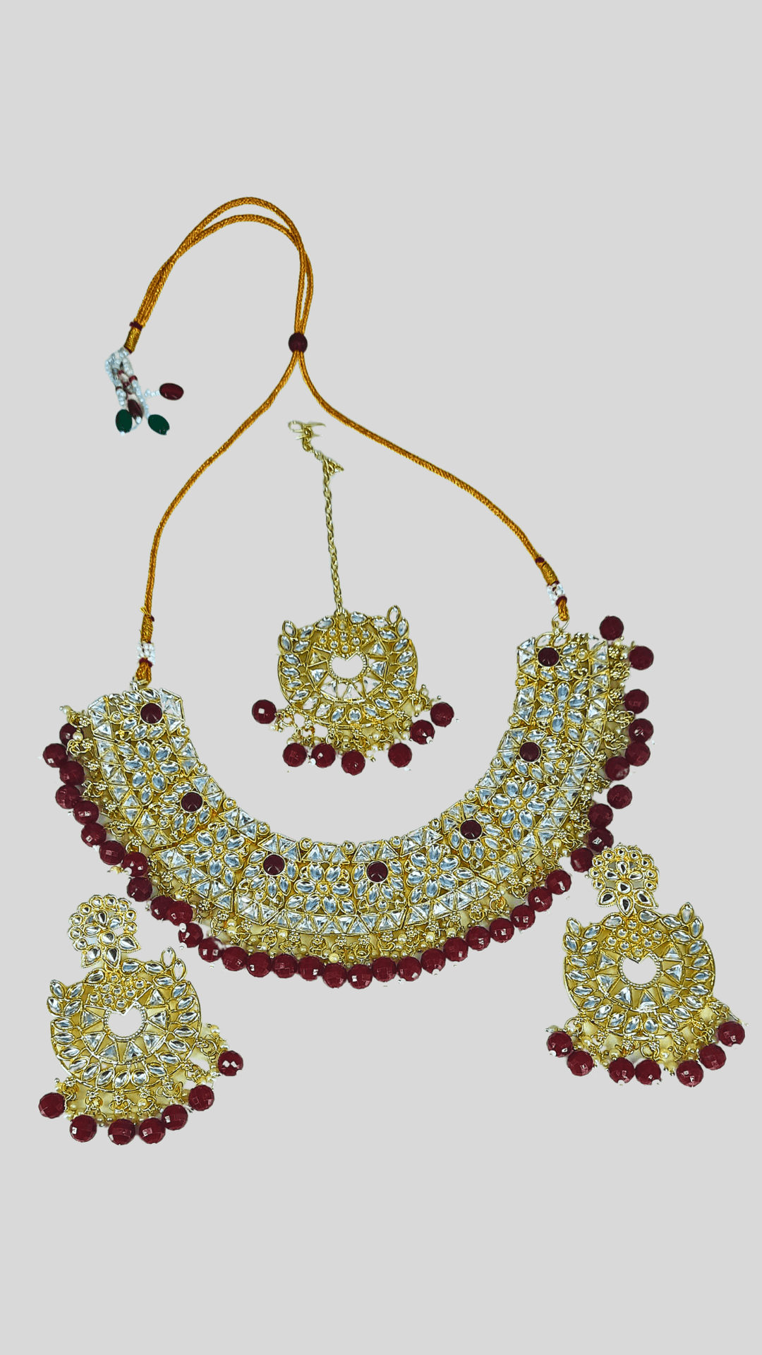 Kundan maroon coloured heavy necklace set with maang tikka